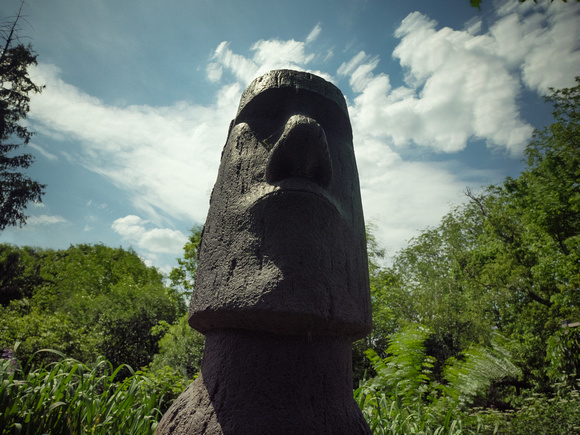 Moai with foliage moving in the wind.